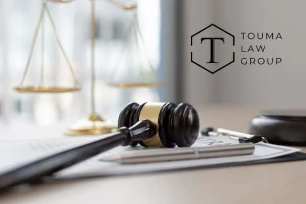 A gavel, scales of justice, and documents on a desk, representing legal proceedings and a law office.